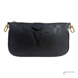 Black textured handbag with gold zippers on a white background