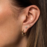 Gabriel & Co. 14K yellow gold pyramid studs worn