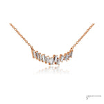 Staggered baguette diamonds in rose gold prongs, angled view
