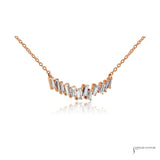Staggered baguette diamonds in rose gold prongs, angled view