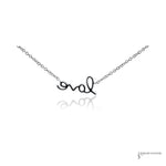 Back of the 14K white gold love script pendant showing the polished finish