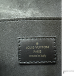 Louis Vuitton label on a textured surface