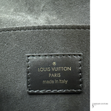 Louis Vuitton label on a textured surface