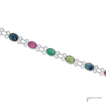 Silver bracelet with multicolored gemstones on a white background