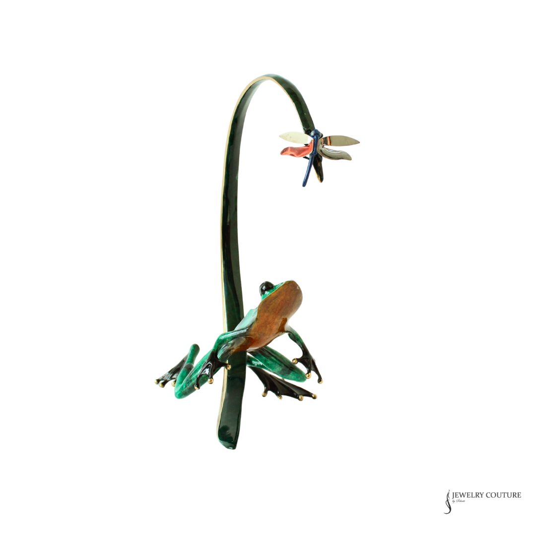 A green frog and snakebite style brooch with a small dragonfly accent, shown on a plain white background.