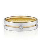 A Verragio two-tone wedding band featuring a polished silver outer band, a yellow gold center stripe, and a central round-cut diamond, with small accent diamonds on the sides and the brand name engraved inside the band.