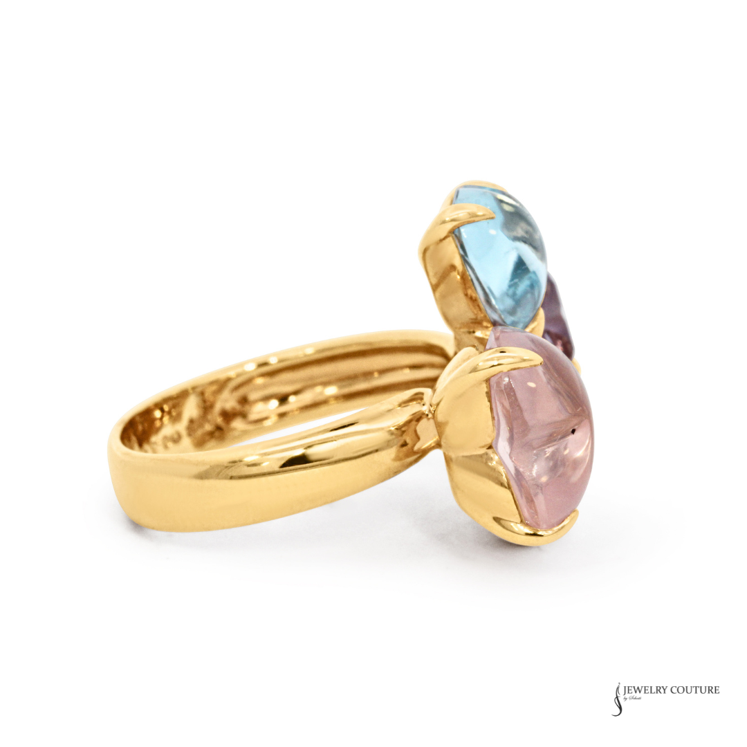 Gold ring with multicolored gemstones on a white background