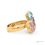 Gold ring with multicolored gemstones on a white background