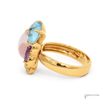 Gold ring with multicolored gemstones on a white background