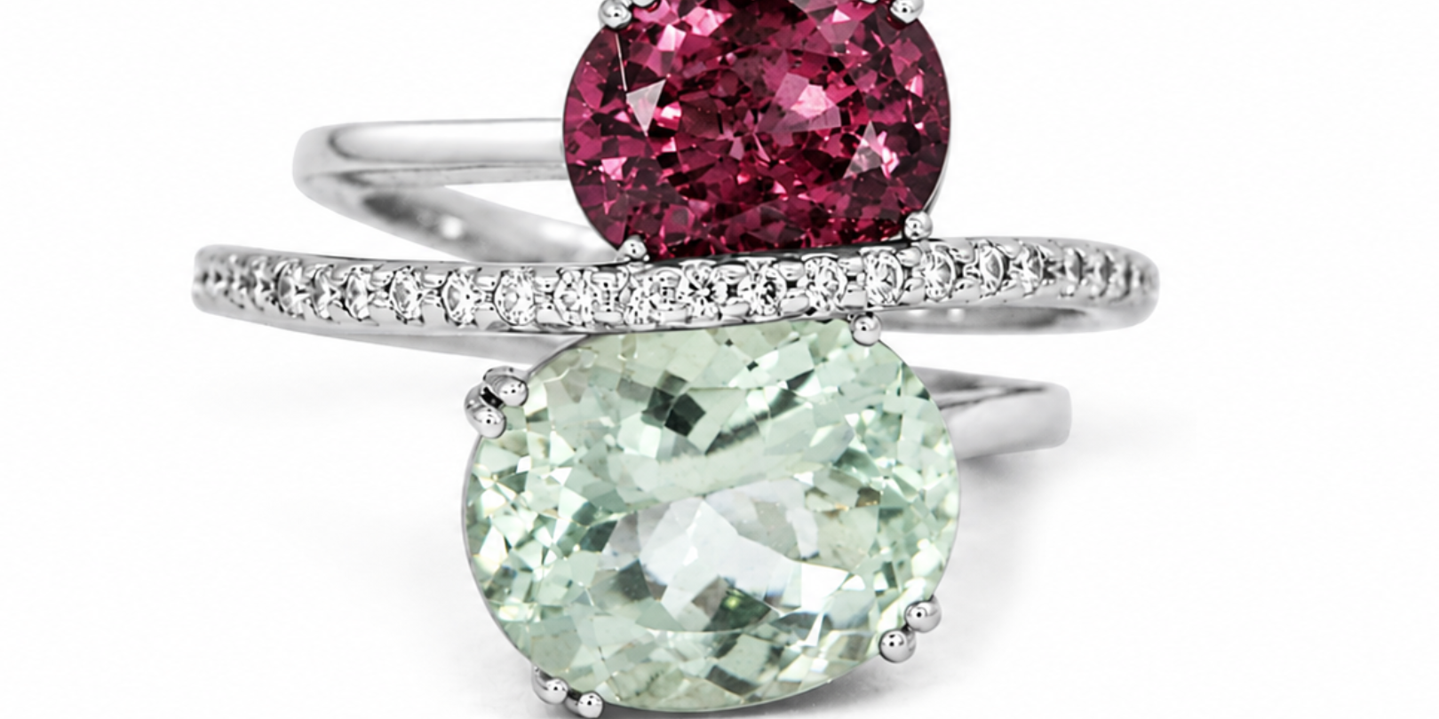 Two gemstone rings with pink and green stones on a white background