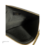 Close-up of a black jewelry case with gold zipper, featuring a visible brand logo.