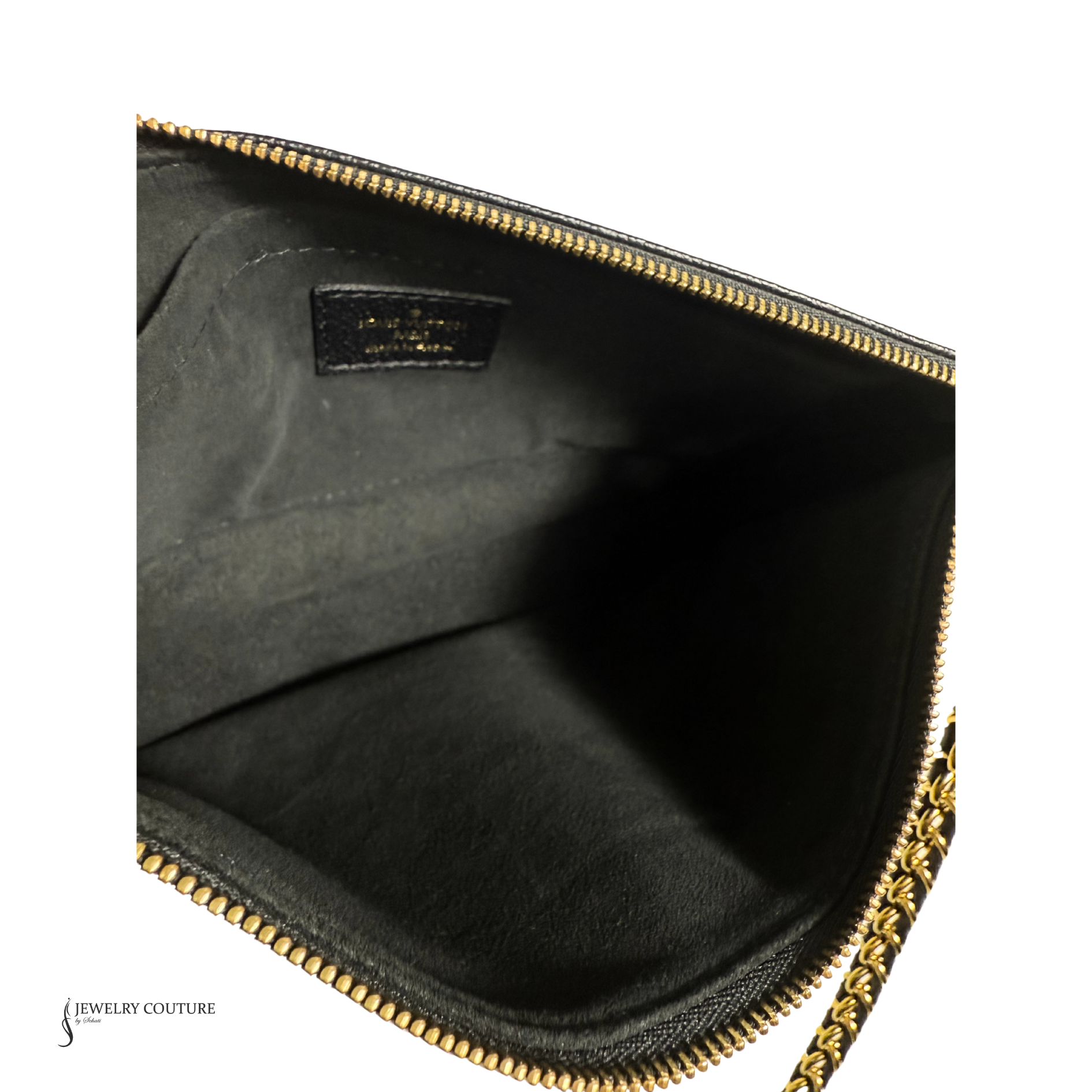 Close-up of a black jewelry case with gold zipper, featuring a visible brand logo.