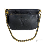 Black handbag with gold chain strap on a white background