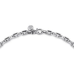 Silver bracelet with a clasp on a white background