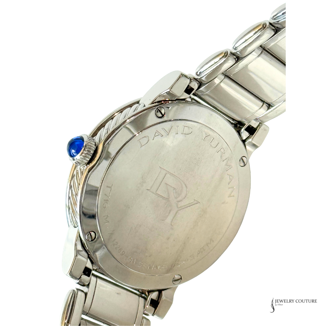 Close-up of the back of a David Yurman watch with a stainless steel bracelet, featuring a blue cabochon accent on the crown and engraved 'DAVID YURMAN' branding on the case.
