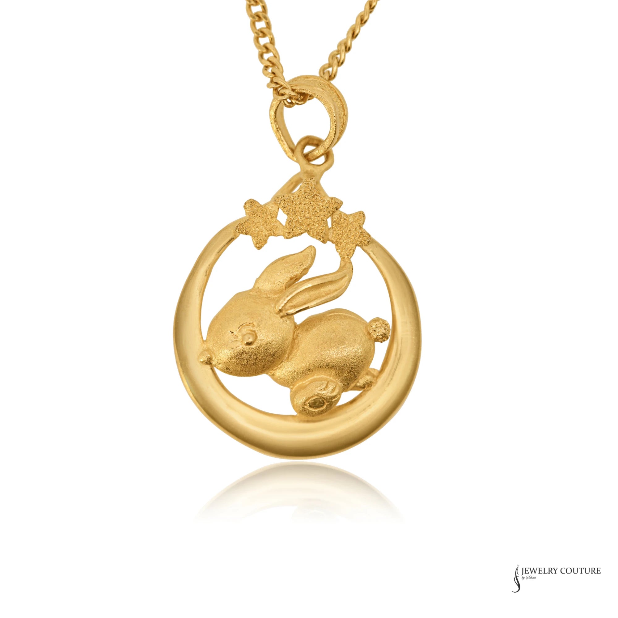 24K gold Year of the Rabbit pendant with rabbit on a crescent moon beneath three stars, close-up view
