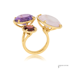 Gold ring with multicolored gemstones on a white background