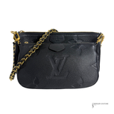 Black handbag with gold chain strap on a white background
