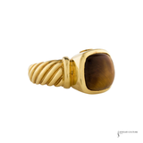 A yellow gold ring featuring a twisted rope band and a large cushion-cut brown tiger's eye stone, shown against a plain white background.