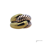 A twisted double-band ring featuring a polished yellow gold band and a central silver-toned band with a textured, ribbed spiral pattern, set against a plain white background.