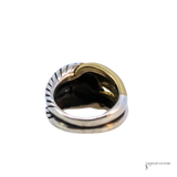 A two-tone metal ring with a textured silver band and a polished gold half, shown from a top-down angle on a white background.