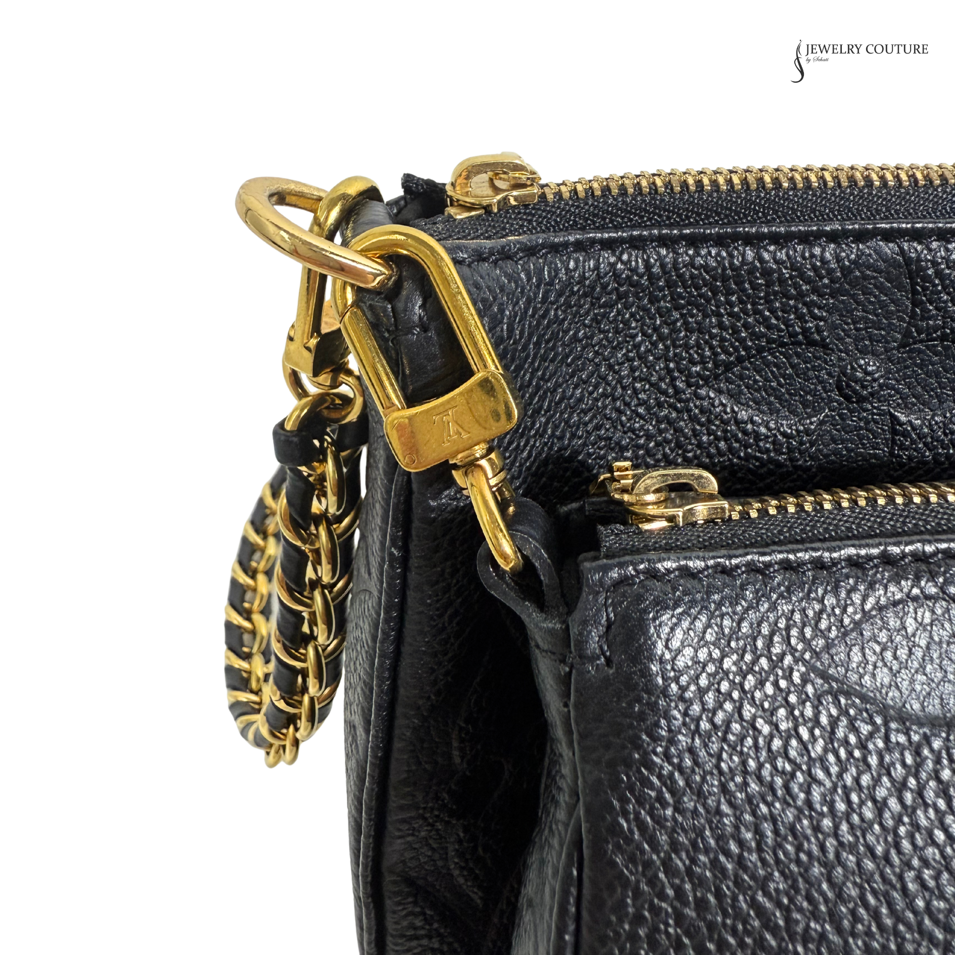 Black leather handbag with gold zipper and chain detail on a white background