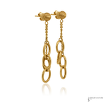 A pair of gold dangle earrings with textured round studs, short chain links, and three larger interlocking oval rings hanging from each earring, shown on a white background with a faint reflection below.