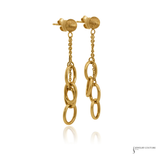 A pair of gold dangle earrings with textured round studs, short chain links, and three larger interlocking oval rings hanging from each earring, shown on a white background with a faint reflection below.