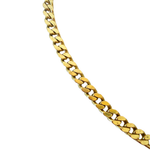 A close-up of a polished yellow gold Cuban link chain running diagonally from the top center to the bottom right on a solid white background.