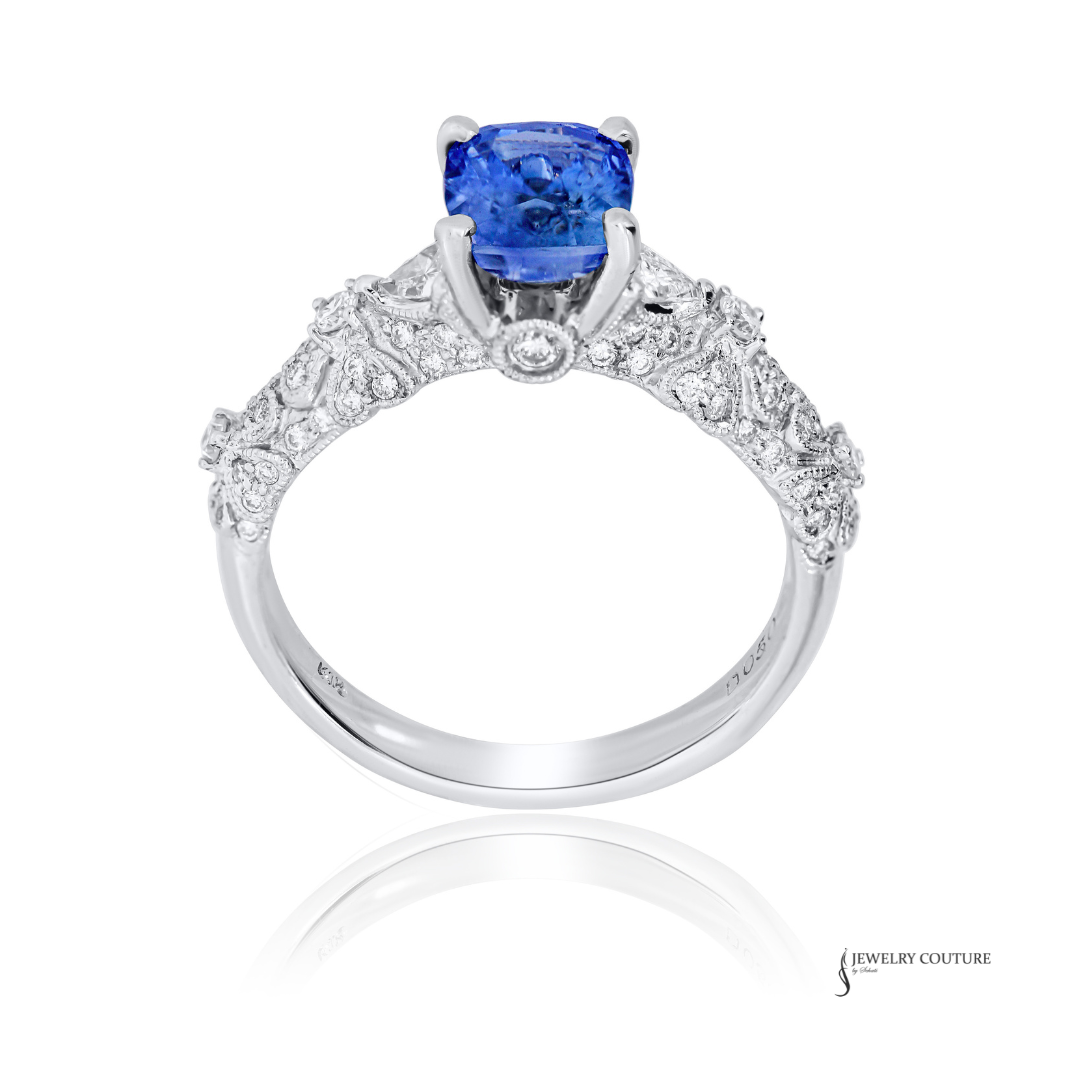 Elegant ring with a blue gemstone and diamond accents on a white background