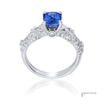 Elegant ring with a blue gemstone and diamond accents on a white background