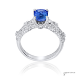 Elegant ring with a blue gemstone and diamond accents on a white background