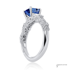 Silver ring with a blue gemstone on a white background
