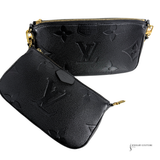 Two black leather pouches with gold zippers on a white background