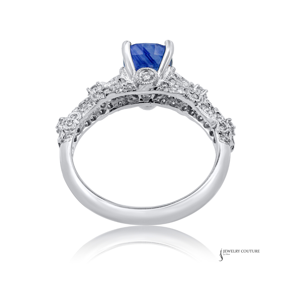Elegant ring with a blue gemstone and diamond accents on a white background