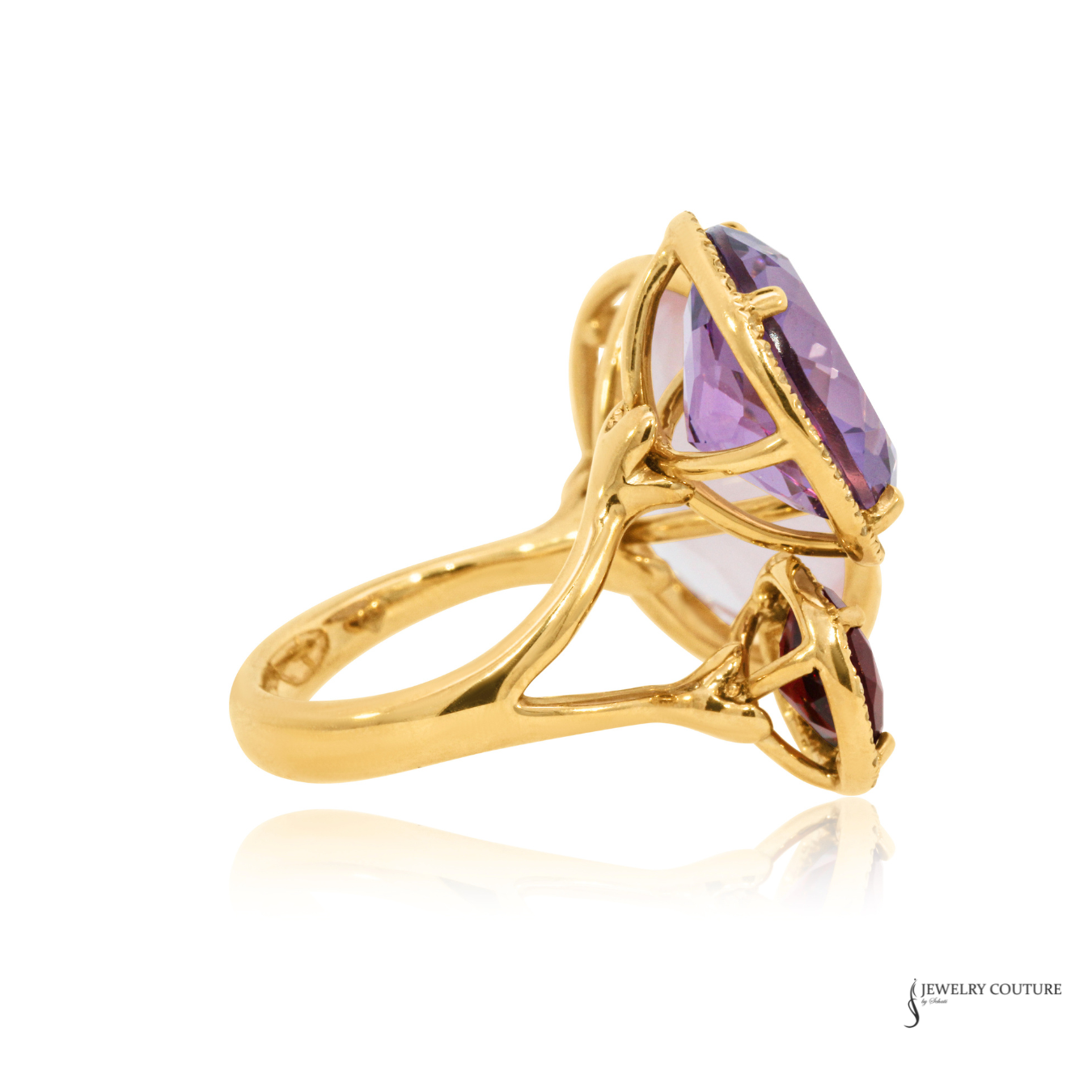 Gold ring with a purple gemstone on a white background