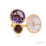 Gold ring with purple, red, and pink gemstones on a white background