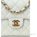 White quilted handbag with gold chain and logo on a white background