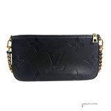 Black handbag with gold chain strap on a white background