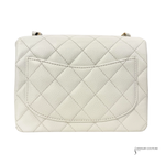 Quilted white handbag on a white background