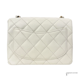 Quilted white handbag on a white background