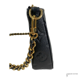 Black leather handbag with gold chain strap on a white background