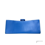 A bright blue leather clutch wallet with a small top tab closure, shown flat against a white background.