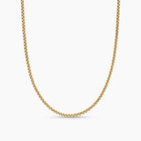 A gold-toned chain necklace with a textured, woven link design, shown against a plain white background.