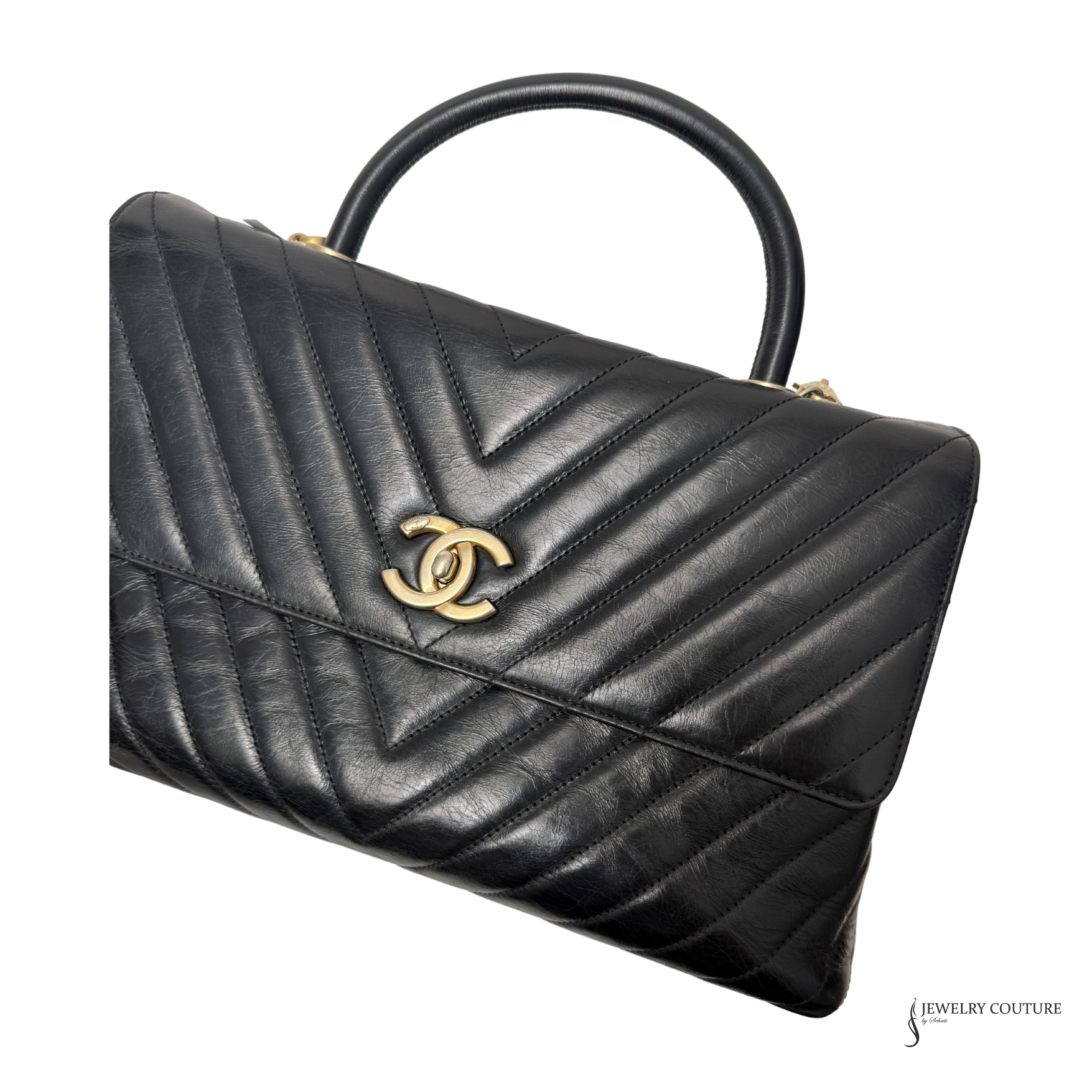 Black quilted handbag with gold logo on a white background