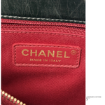Close-up of a Chanel logo on red fabric with 'Made in Italy' text.