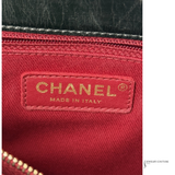 Close-up of a Chanel logo on red fabric with 'Made in Italy' text.
