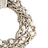 A close-up of a multi-strand bracelet featuring silver-tone chain links, braided chain, and white pearl beads on a plain white background.