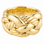 A polished yellow gold ring with a thick, sculptural design featuring interlocking twisted and ribbed bands, photographed on a seamless white background.