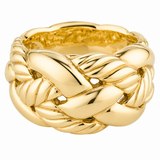 A polished yellow gold ring with a thick, sculptural design featuring interlocking twisted and ribbed bands, photographed on a seamless white background.